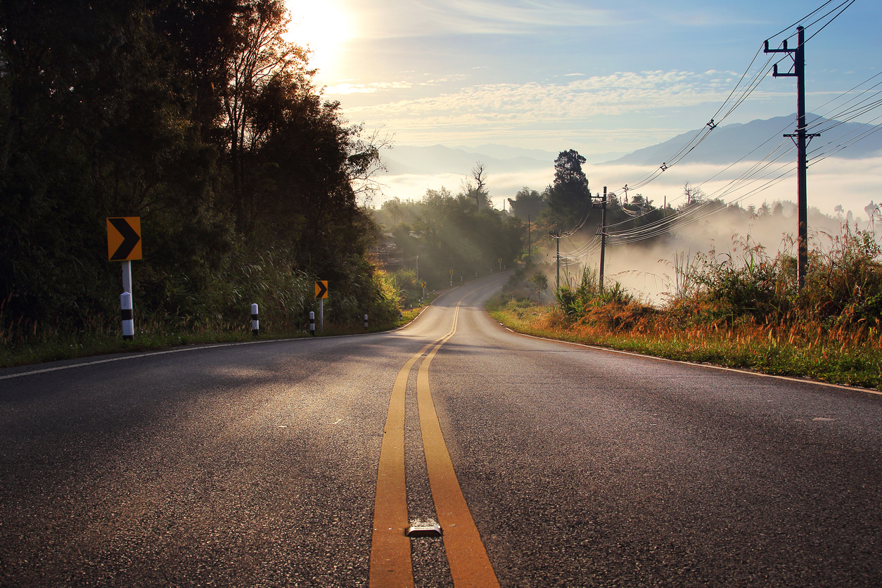 route and journey during sunrise with the mist